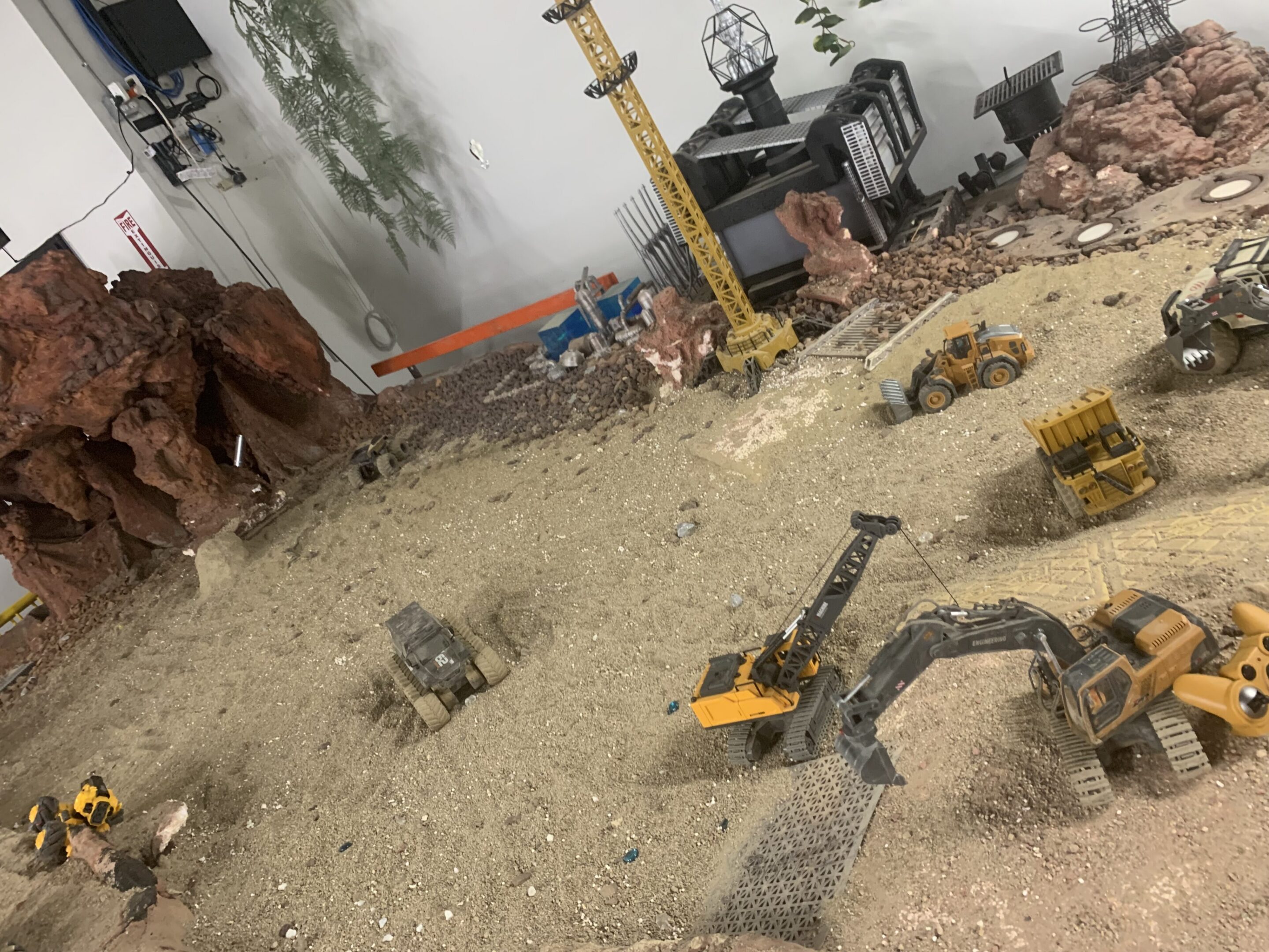 Miniature construction site with toy excavators